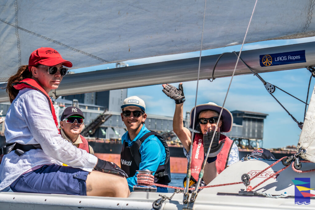People on a sailing boat, waving and happy